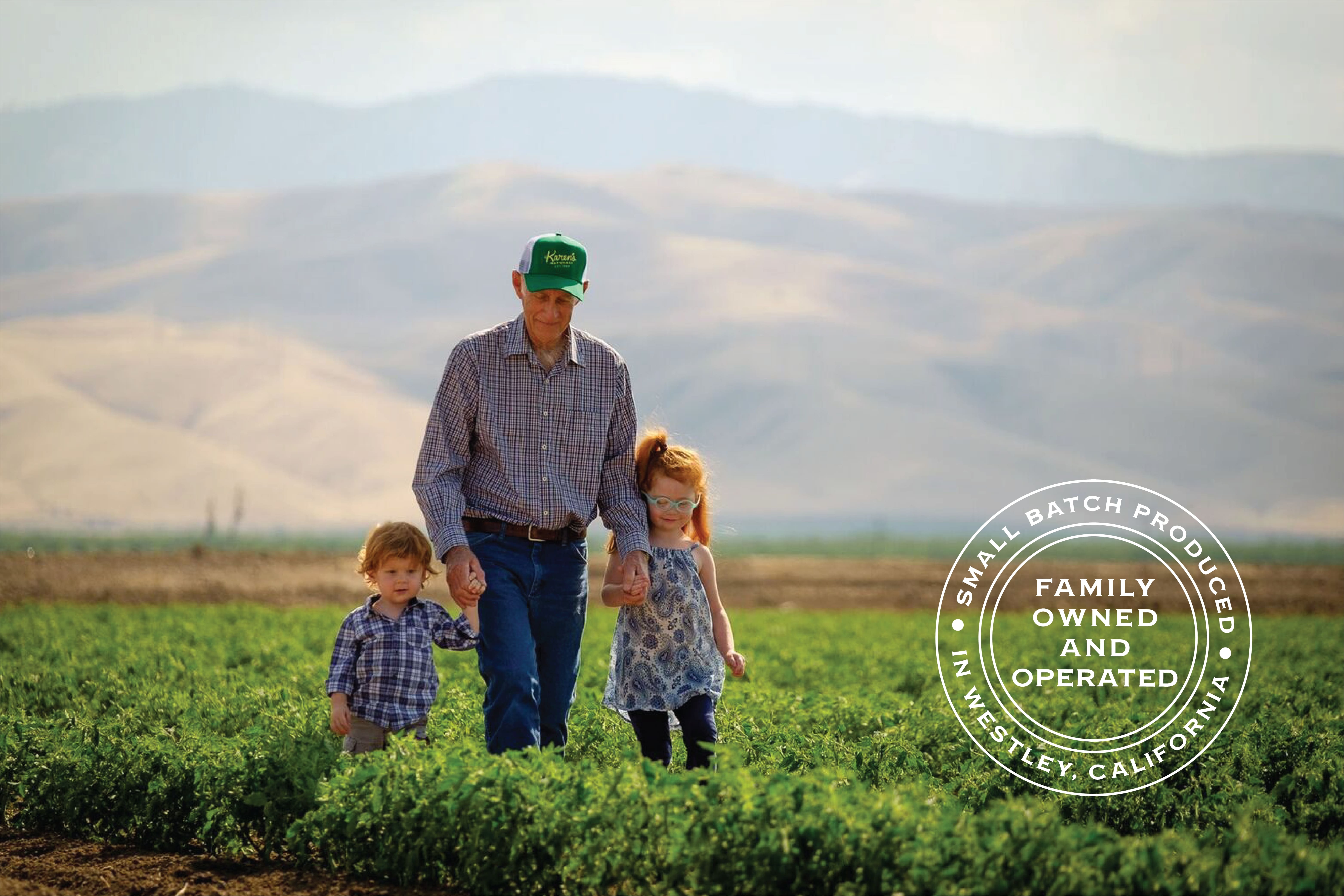 Farmer Bill, the patriarch of Karen's Natuals, with his grandkids walking in the field or crops. 