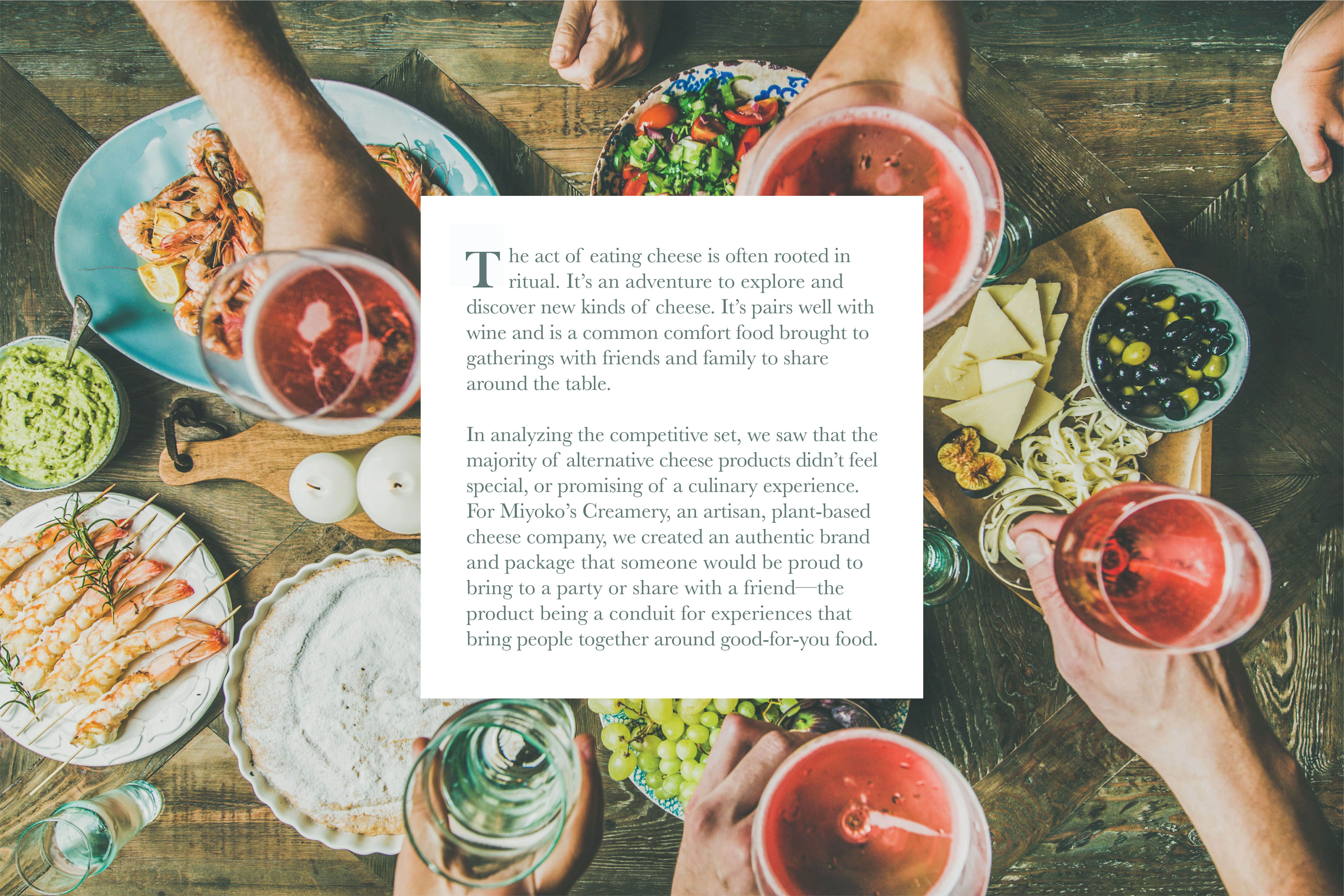 Friends gathering around the table with food and drink with copy talking about the rituals that surround cheese.